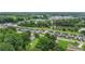 Scenic aerial shot of townhomes nestled by a picturesque lake and verdant trees, showcasing a tranquil community at 2326 Britt St, Grayson, GA 30017
