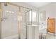 Well-lit bathroom with glass enclosed shower and separate soaking tub at 2326 Britt St, Grayson, GA 30017