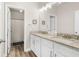 Elegant bathroom featuring double sinks, granite countertops, and wood-look flooring for a luxurious feel at 2326 Britt St, Grayson, GA 30017