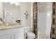Well-lit bathroom with granite countertops, a framed mirror, and shower, creating a functional space at 2326 Britt St, Grayson, GA 30017