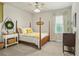 Cozy bedroom with natural light, featuring a four-poster bed, and soft hues for a serene retreat at 2326 Britt St, Grayson, GA 30017