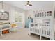 Bright bedroom with a white bunk bed, desk, and ceiling fan, offering a cozy and functional space at 2326 Britt St, Grayson, GA 30017