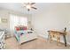 Inviting bedroom showcasing a comfortable bed, modern desk, and ample natural light for a relaxing ambiance at 2326 Britt St, Grayson, GA 30017
