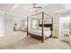 Spacious bedroom featuring a four-poster bed, sitting area, and neutral walls at 2326 Britt St, Grayson, GA 30017
