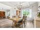 Elegant dining room featuring a wooden table, modern chandelier, large window, and hardwood flooring at 2326 Britt St, Grayson, GA 30017