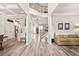 Open-concept entryway with hardwood floors, coffered ceilings, and staircase leading to the second level, flowing into kitchen at 2326 Britt St, Grayson, GA 30017