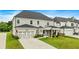Desirable two-story townhome with attached garage and well-maintained landscaping, showcasing its curb appeal at 2326 Britt St, Grayson, GA 30017