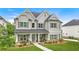 Beautiful two-story home with manicured lawn, stone accents, and covered front porch at 2326 Britt St, Grayson, GA 30017