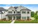 Charming two-story home with manicured lawn and covered front porch with stone accents and neutral-colored siding at 2326 Britt St, Grayson, GA 30017