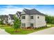 Two-story home with siding, dark roof, green lawn, and professional landscaping at 2326 Britt St, Grayson, GA 30017