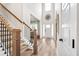 Open foyer featuring hardwood floors, a staircase, and a front door with lots of light at 2326 Britt St, Grayson, GA 30017
