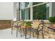 Cozy front porch seating area with stone detailing, comfortable chairs, and decorative pillows at 2326 Britt St, Grayson, GA 30017