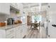 Modern kitchen with white cabinets, granite counters, and view to the dining area at 2326 Britt St, Grayson, GA 30017