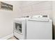 Efficient laundry room equipped with modern appliances and ample shelving for convenient organization at 2326 Britt St, Grayson, GA 30017