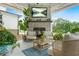 Inviting covered patio features a brick fireplace and comfortable seating area, perfect for outdoor relaxation at 2326 Britt St, Grayson, GA 30017