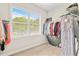 Walk-in closet with organized storage solutions and natural light from the window at 2326 Britt St, Grayson, GA 30017