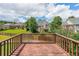 A home's back deck and a green backyard with a view of neighboring houses and sky at 2684 Mountain Oaks Ct, Powder Springs, GA 30127