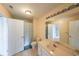 Neutral bathroom featuring a double sink vanity and a shower with a striped curtain at 2684 Mountain Oaks Ct, Powder Springs, GA 30127