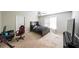 Spacious bedroom featuring a bed, desk and chair at 2684 Mountain Oaks Ct, Powder Springs, GA 30127