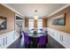 Formal dining room with decorative wainscoting and modern chandelier at 2684 Mountain Oaks Ct, Powder Springs, GA 30127