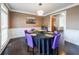 Elegant dining room with hardwood floors, wainscoting, and a stylish table setting at 2684 Mountain Oaks Ct, Powder Springs, GA 30127