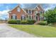 Lovely brick home showcasing a well-manicured lawn and driveway, enhancing its curb appeal at 2684 Mountain Oaks Ct, Powder Springs, GA 30127