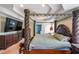 Luxurious main bedroom featuring a four-poster bed and a trey ceiling at 2684 Mountain Oaks Ct, Powder Springs, GA 30127