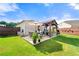 A backyard featuring a patio with grill, a covered gazebo with seating and dining, grass lawn, and wooden fencing at 3735 Westhaven Dr, Cumming, GA 30040