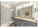 Bathroom featuring double sinks with granite counters, grey cabinets, neutral paint and a glass shower stall at 3735 Westhaven Dr, Cumming, GA 30040