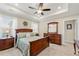 Comfortable bedroom showcasing a decorative ceiling, ceiling fan and neutral walls with a wooden furniture set at 3735 Westhaven Dr, Cumming, GA 30040