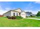 Beautifully landscaped lawn around this single Gathering home featuring a two-car garage and patriotic American flag at 3735 Westhaven Dr, Cumming, GA 30040