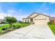 Well maintained front lawn with fresh landscaping surrounds this tan home with a two-car garage at 3735 Westhaven Dr, Cumming, GA 30040