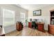 Well-lit home office with wood floors, two windows, and handsome desk and file cabinet set at 3735 Westhaven Dr, Cumming, GA 30040