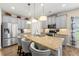 Light and bright kitchen with gray cabinets, granite countertops, an island with bar seating, and stainless appliances at 3735 Westhaven Dr, Cumming, GA 30040