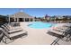 Community pool featuring a light blue water, pool furniture, and a pool house under a clear blue sky at 3735 Westhaven Dr, Cumming, GA 30040