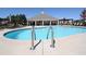 Community pool featuring a light blue water, pool furniture, and a pool house under a clear blue sky at 3735 Westhaven Dr, Cumming, GA 30040