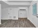 Finished basement space with wood-look flooring, white walls, and exterior access at 4520 Coopers Creek Se Cir, Smyrna, GA 30082
