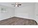 Well-lit bedroom with wood floors, a ceiling fan, and a window at 4520 Coopers Creek Se Cir, Smyrna, GA 30082
