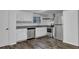 Modern kitchenette with stainless steel appliances, white cabinets, and tiled backsplash at 4520 Coopers Creek Se Cir, Smyrna, GA 30082