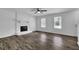 Bright living room featuring a decorative white stone fireplace and modern flooring at 4520 Coopers Creek Se Cir, Smyrna, GA 30082