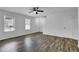 Light-filled living room showcasing wood-look flooring, white walls, and a ceiling fan at 4520 Coopers Creek Se Cir, Smyrna, GA 30082
