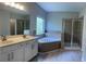 Primary bathroom featuring a double vanity, soaking tub, and separate shower at 4865 Fourth Rail Ln, Cumming, GA 30040