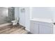 Modern bathroom features a tiled shower, updated vanity, and wood-look flooring at 4865 Fourth Rail Ln, Cumming, GA 30040