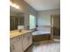 The primary bathroom features a soaking tub, glass shower, and double sink vanity at 4865 Fourth Rail Ln, Cumming, GA 30040
