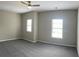 Bedroom with gray carpet, neutral walls, and two windows at 4865 Fourth Rail Ln, Cumming, GA 30040