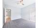 A cozy bedroom features a ceiling fan and neutral gray carpet at 4865 Fourth Rail Ln, Cumming, GA 30040