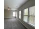 Bedroom with gray carpet, neutral walls, ceiling fan and large windows at 4865 Fourth Rail Ln, Cumming, GA 30040