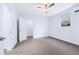 Bright bedroom featuring neutral carpeting, a ceiling fan, and a window allowing ample natural light at 4865 Fourth Rail Ln, Cumming, GA 30040