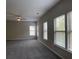 Spacious bedroom with neutral walls, plush gray carpet, and lots of natural light from the many windows at 4865 Fourth Rail Ln, Cumming, GA 30040