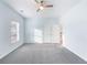 Bedroom boasts gray carpet, natural light and an open doorway at 4865 Fourth Rail Ln, Cumming, GA 30040